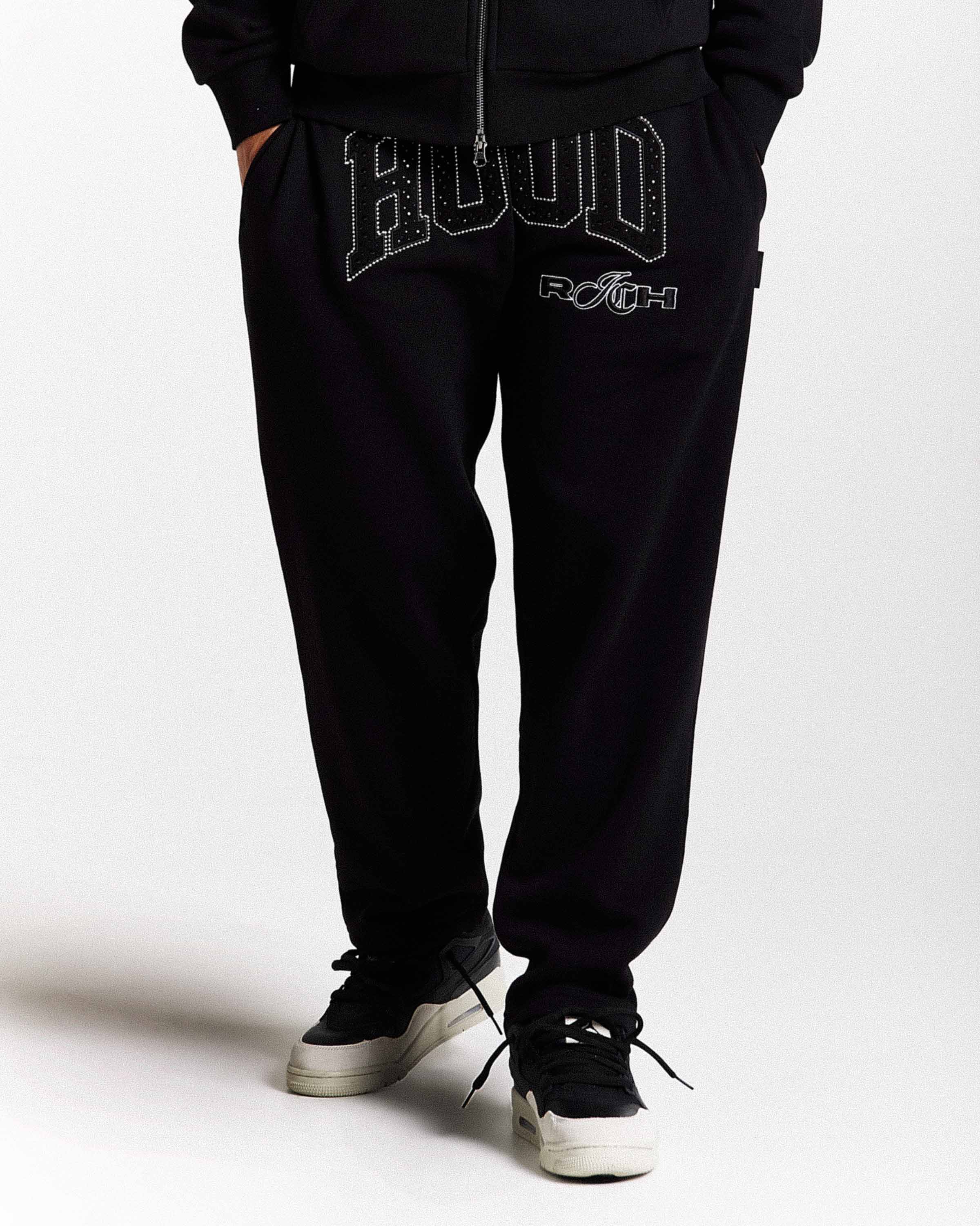 Black sweatpants with 'HOODRICH' text on a white background
