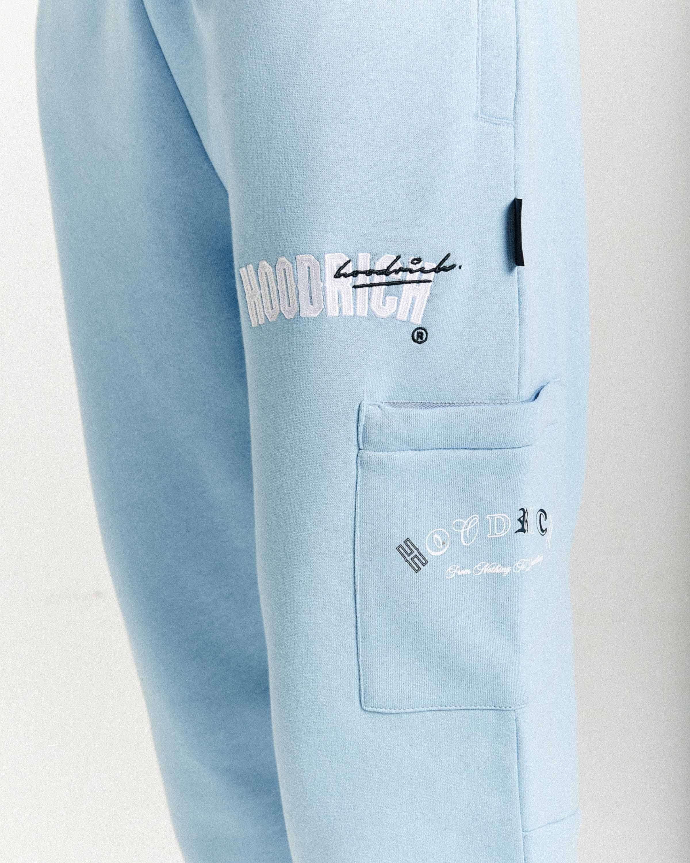 Light blue pants with 'Hoodrich' branding on a white background