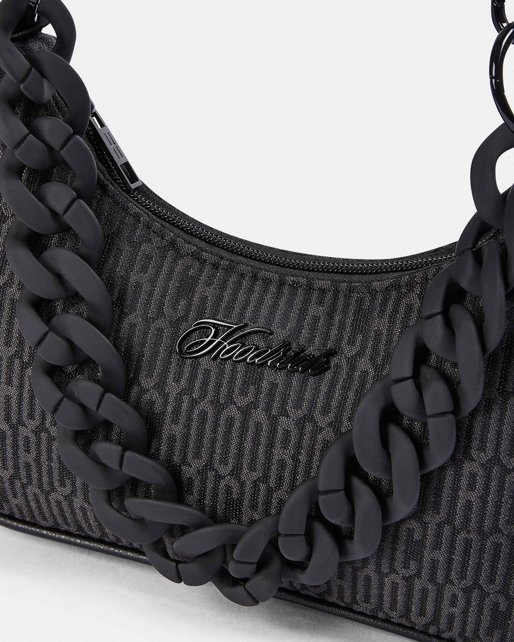 Black handbag with chain detail and visible brand logo on a white background